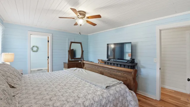 a bedroom with a bed and a chandelier