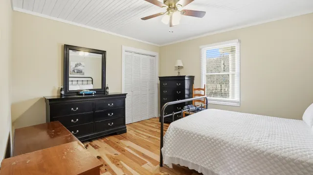 a bedroom with furniture and a window