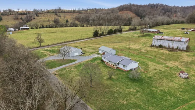 an aerial view of a house with a yard