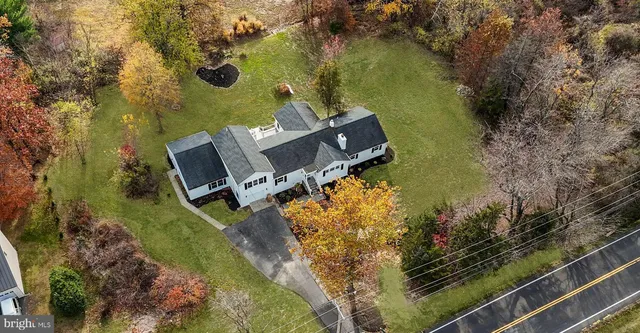 an aerial view of a house with a lake view