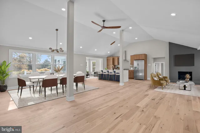 a view of a room with furniture and wooden floor