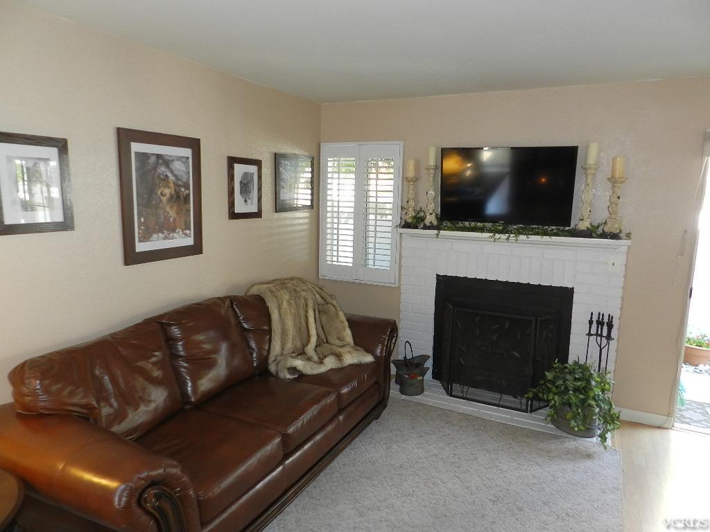 1866 Rory Lane, Unit 2 Simi Valley, CA 93063 - Photo 11 of 31 a living room with furniture a flat screen tv and a fireplace