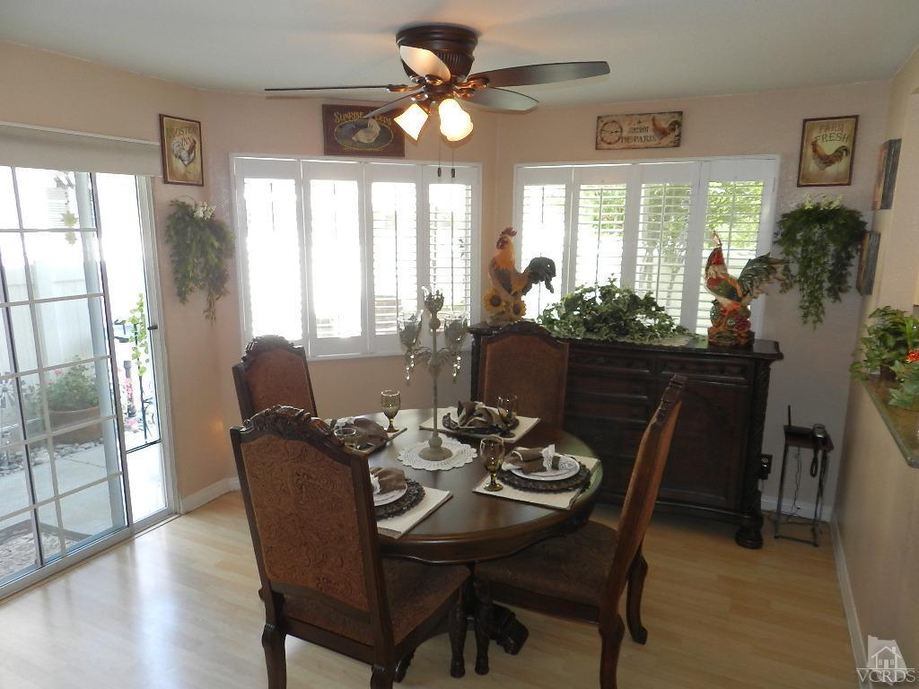 1866 Rory Lane, Unit 2 Simi Valley, CA 93063 - Photo 13 of 31 a dining room with furniture a chandelier and wooden floor