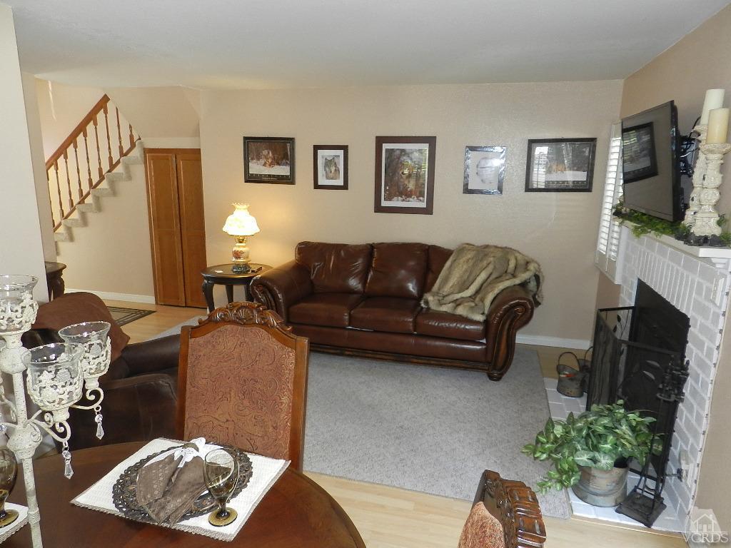 1866 Rory Lane, Unit 2 Simi Valley, CA 93063 - Photo 15 of 31 a living room with furniture a fireplace and a flat screen tv