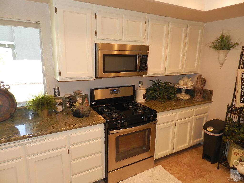 1866 Rory Lane, Unit 2 Simi Valley, CA 93063 - Photo 17 of 31 a kitchen with a stove and a microwave