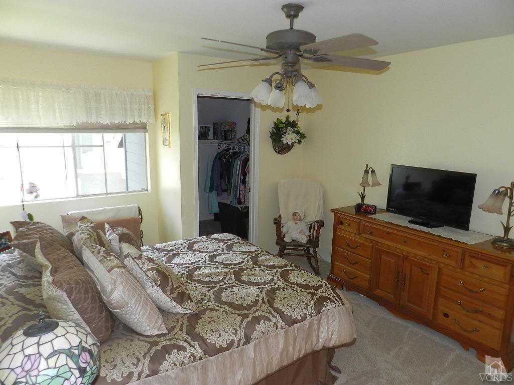 1866 Rory Lane, Unit 2 Simi Valley, CA 93063 - Photo 20 of 31 a bedroom with a bed and a flat screen tv