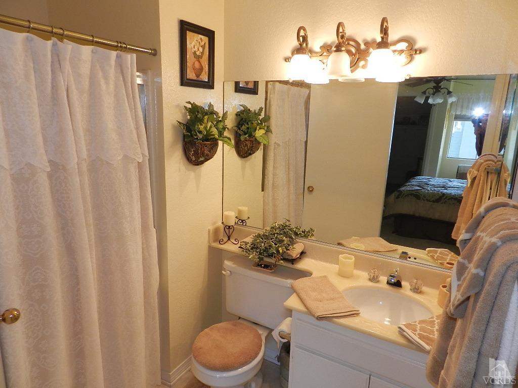 1866 Rory Lane, Unit 2 Simi Valley, CA 93063 - Photo 21 of 31 a bathroom with a sink a toilet and shower curtain