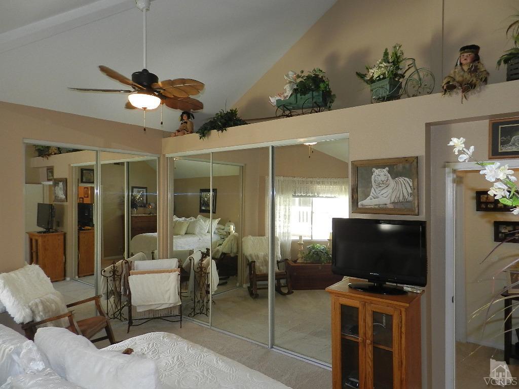 1866 Rory Lane, Unit 2 Simi Valley, CA 93063 - Photo 23 of 31 a living room with furniture a flat screen tv and a floor to ceiling window