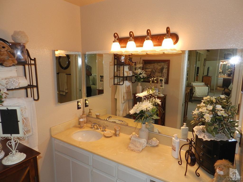 1866 Rory Lane, Unit 2 Simi Valley, CA 93063 - Photo 25 of 31 a bathroom with a sink and a mirror