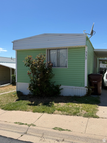 335 Hillgate Way Layton, UT 84041 - Photo 1 of 5 Light green siding exterior with white trim and a covered carport
