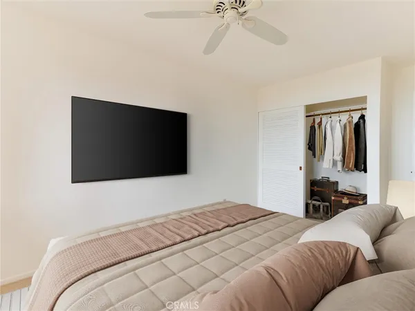 a bedroom with a large bed and a chandelier