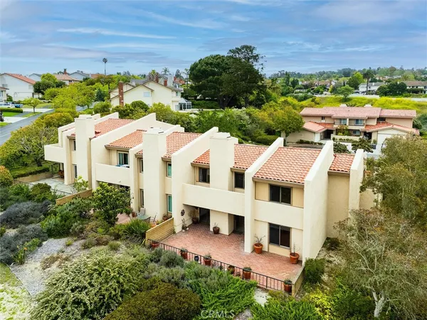 an aerial view of residential houses with outdoor space and street view