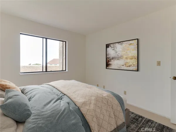 a bedroom with a bed and the couch