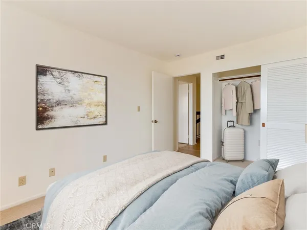 a spacious bedroom with a bed and a couch