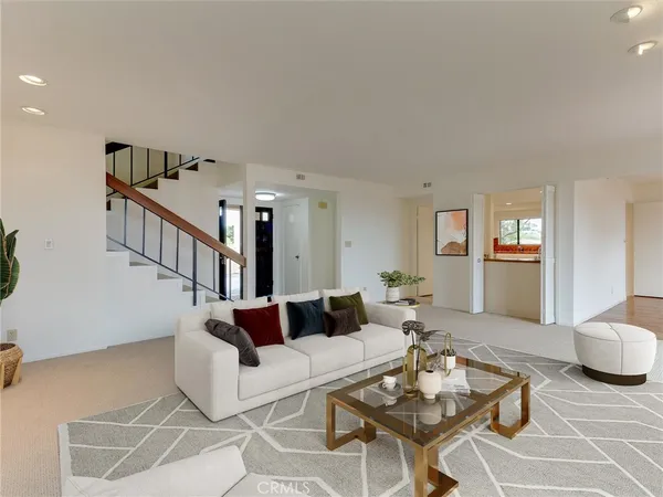 a living room with furniture fireplace and a large window