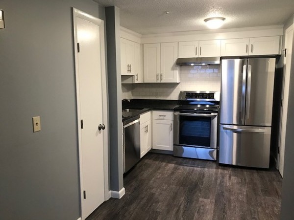 135 Creek Street, Unit 9 Wrentham, MA 02093 - Photo 1 of 15 a kitchen with a refrigerator sink and stove top oven