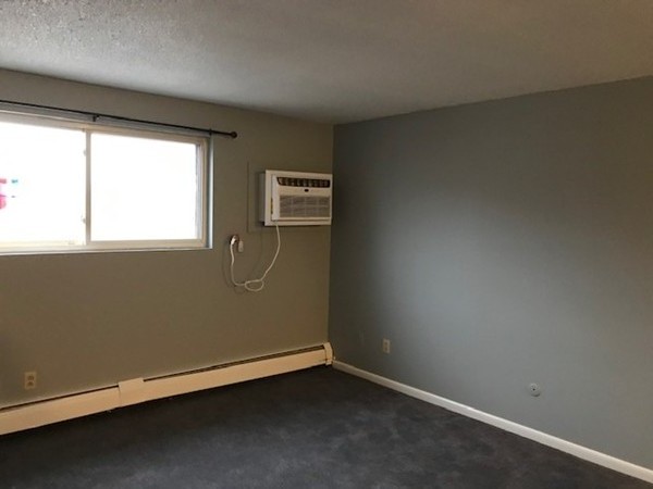 135 Creek Street, Unit 9 Wrentham, MA 02093 - Photo 13 of 15 an empty room with windows