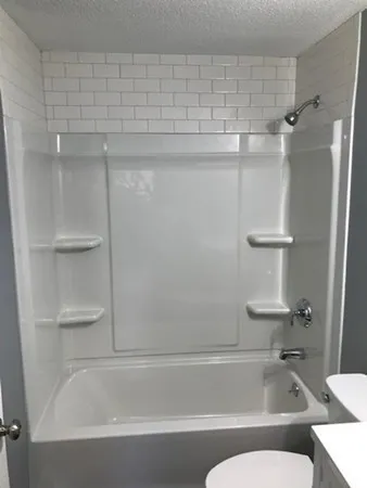 a bathroom with a bathtub and toilet
