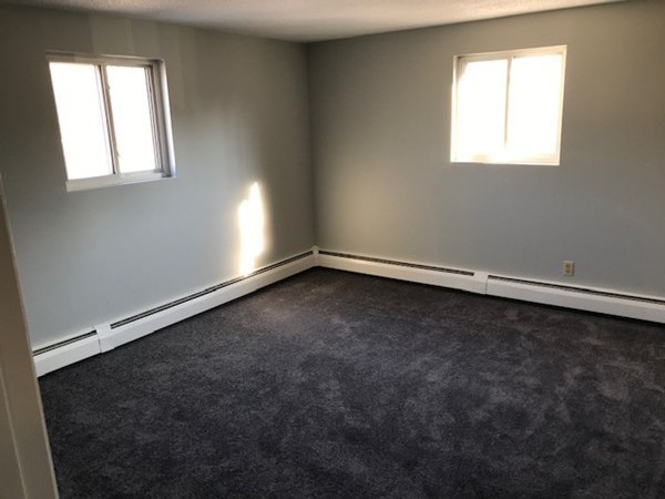 135 Creek Street, Unit 9 Wrentham, MA 02093 - Photo 9 of 15 an empty room with a window