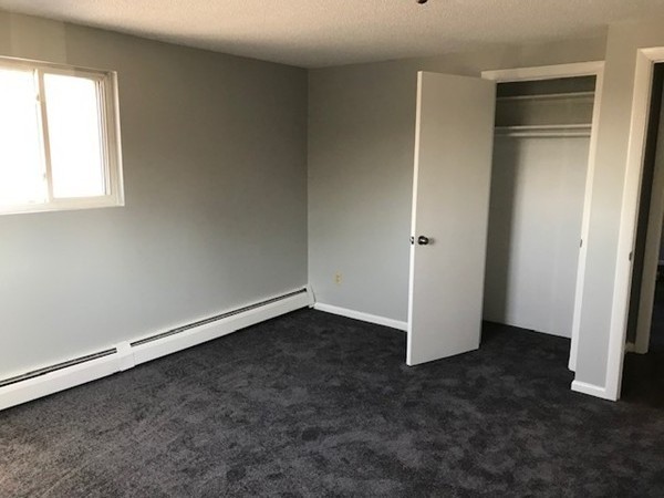 135 Creek Street, Unit 9 Wrentham, MA 02093 - Photo 10 of 15 an empty room with a door