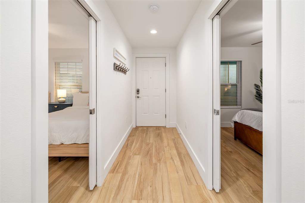 15305 1st Street East, Unit 201 Madeira Beach, FL 33708 - Photo 14 of 41 a view of a bedroom from a hallway