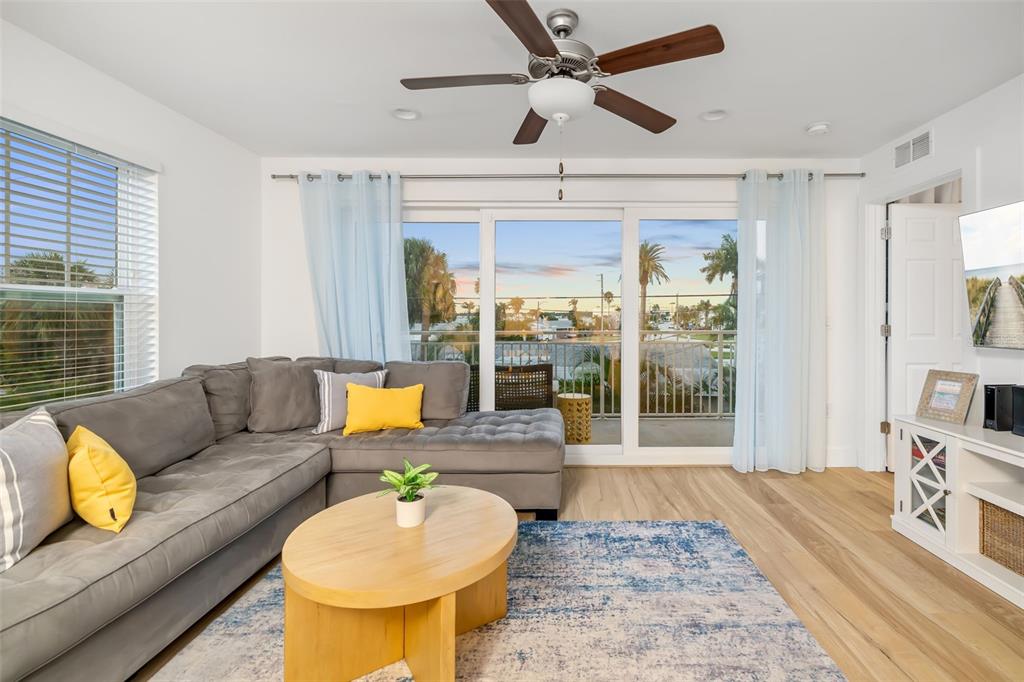 15305 1st Street East, Unit 201 Madeira Beach, FL 33708 - Photo 16 of 41 a living room with furniture and a large window