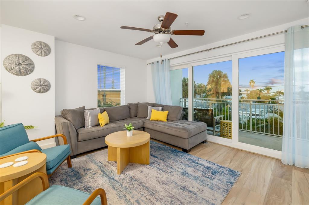 15305 1st Street East, Unit 201 Madeira Beach, FL 33708 - Photo 17 of 41 a living room with furniture and a window