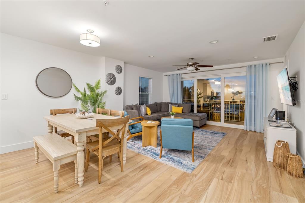 15305 1st Street East, Unit 201 Madeira Beach, FL 33708 - Photo 23 of 41 a view of a dining room with furniture window and wooden floor