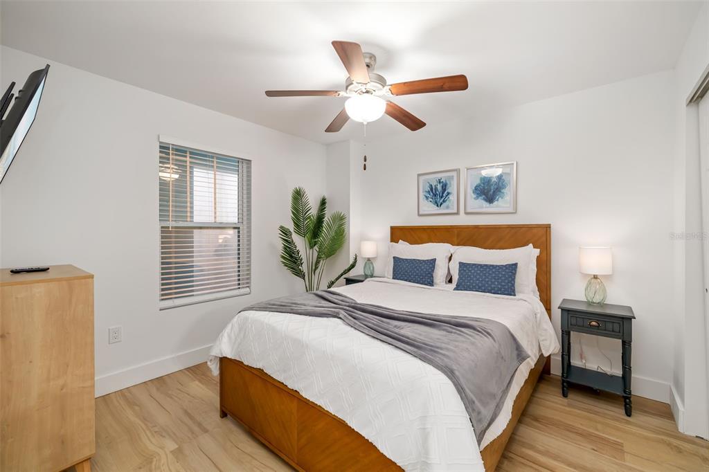 15305 1st Street East, Unit 201 Madeira Beach, FL 33708 - Photo 30 of 41 a bedroom with bed and a window