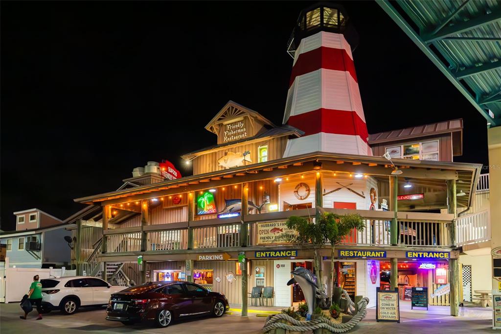 15305 1st Street East, Unit 201 Madeira Beach, FL 33708 - Photo 39 of 41 a view of parking area with parked cars