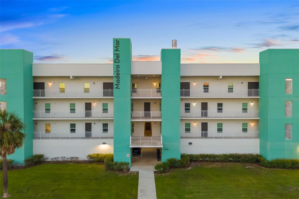 15305 1st Street East, Unit 201 Madeira Beach, FL 33708 - Photo 8 of 41 a view of a building with a yard