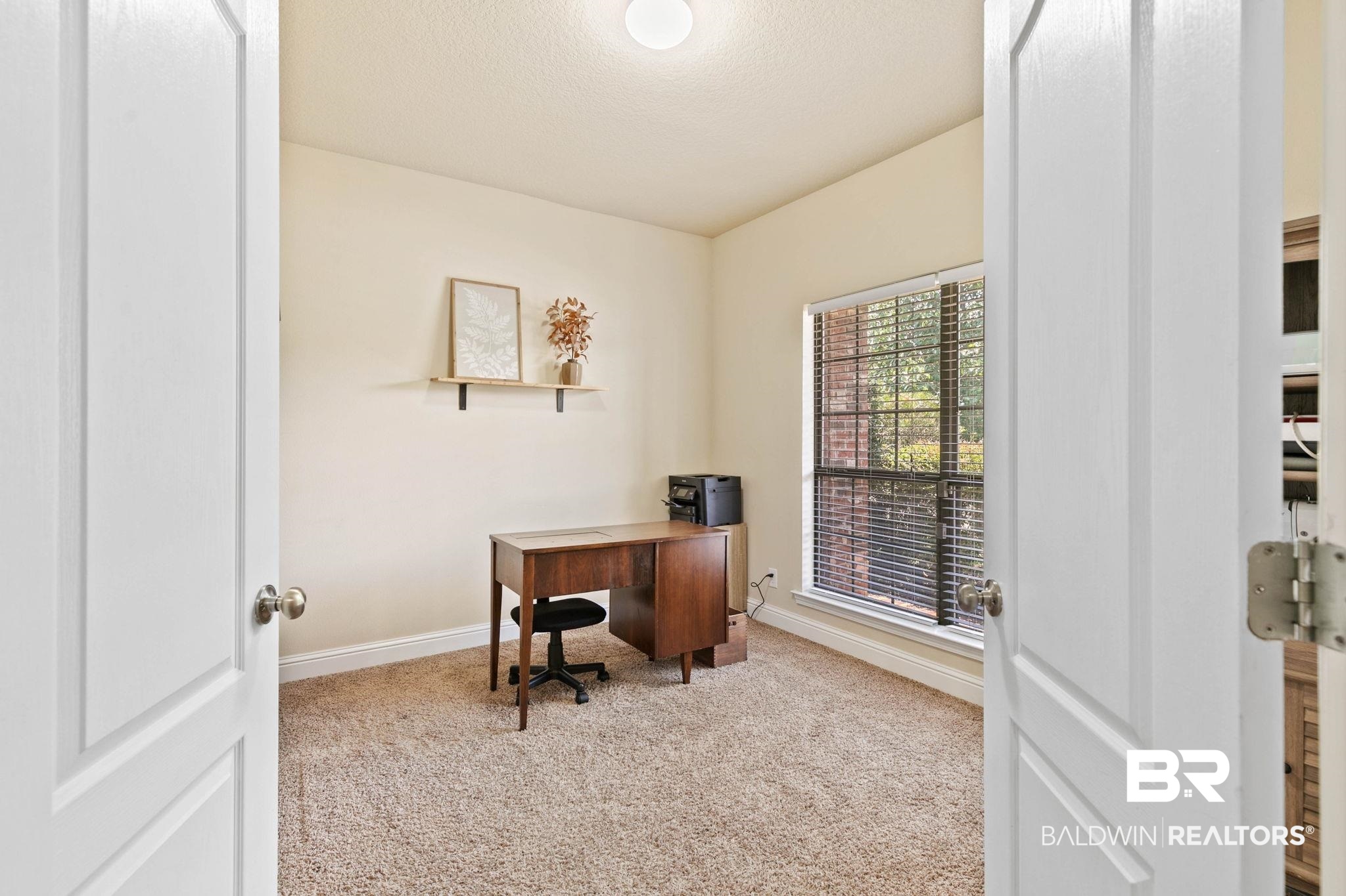 2216 Livingstone Court Mobile, AL 36695 - Photo 29 of 62 Carpeted room with a large window, white baseboards, and a neutral wall color