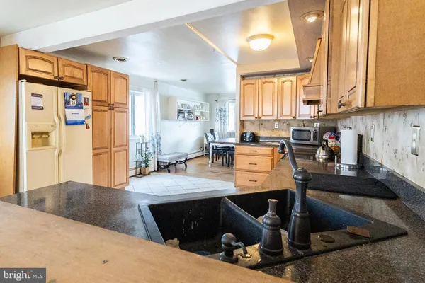 a view of a kitchen with kitchen island cabinets and furniture