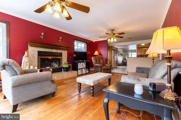 a living room with furniture a fireplace and a chandelier