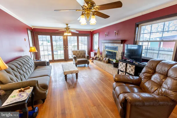 a living room with furniture fireplace and a large window