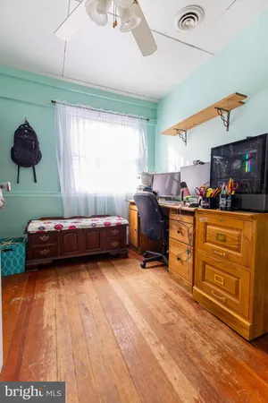 a bedroom with furniture and a window