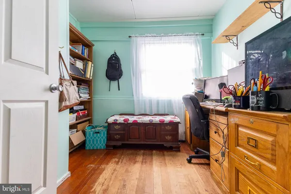 a bedroom with a baby bed baby crib and a dresser next to a window