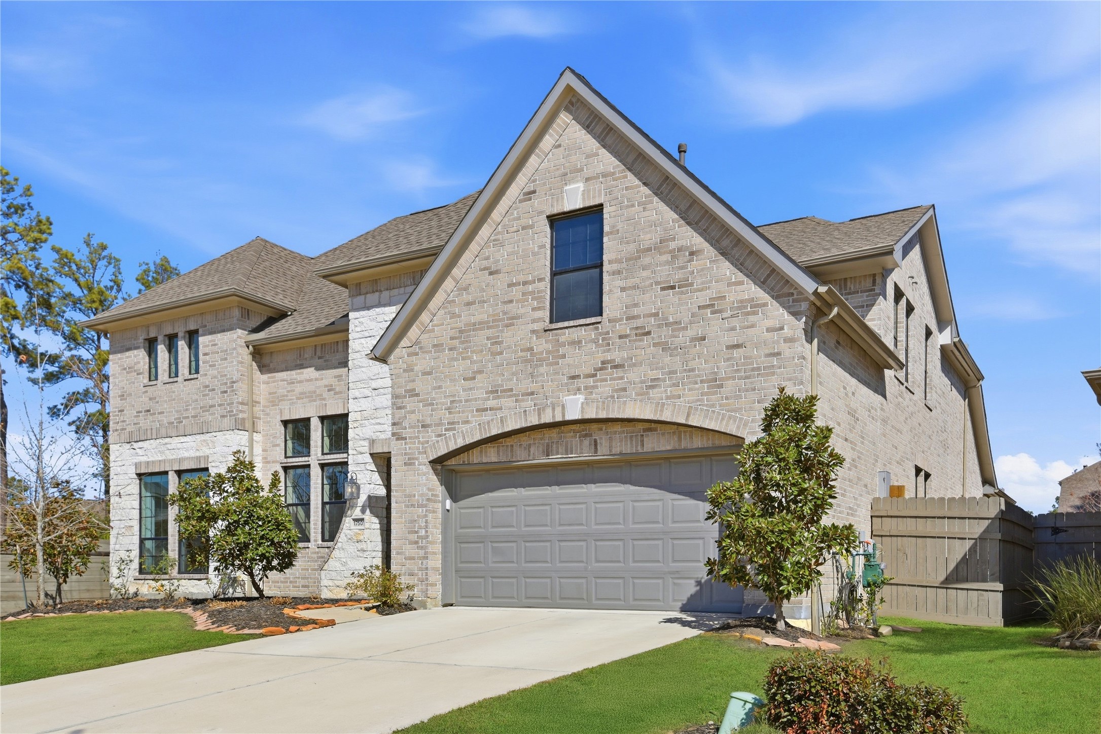 17501 Spice Merlot Lane Conroe, TX 77302 - Photo 3 of 50 a front view of a house with a yard