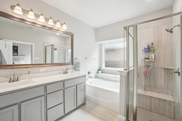 a bathroom with a double vanity sink mirror and double