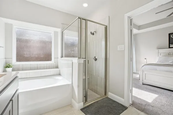a bathroom with a tub shower and sink