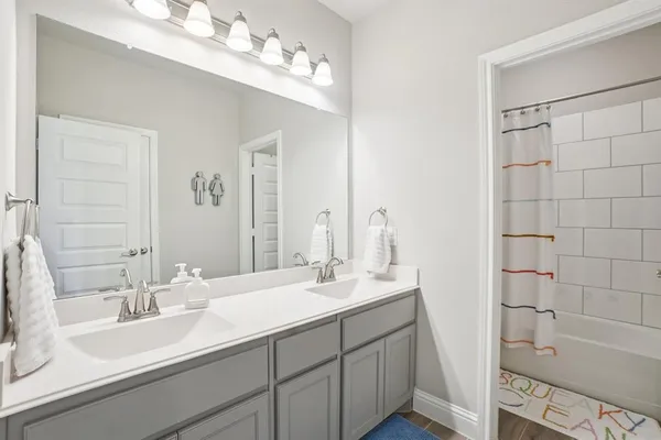 a bathroom with a double vanity sink mirror and double