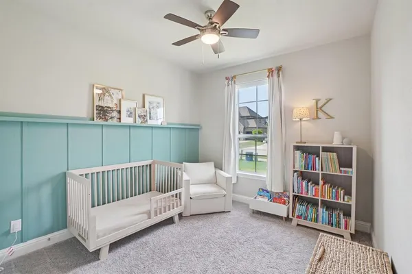 a bedroom with furniture and a book shelf