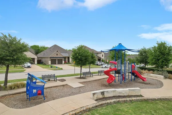 a view of outdoor space with playground and green space