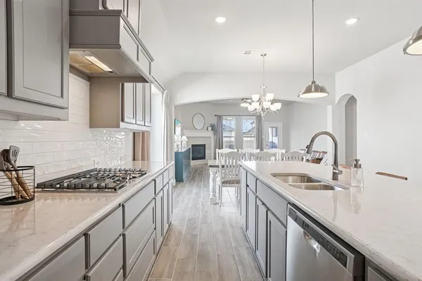a kitchen with counter top space a stove and cabinets