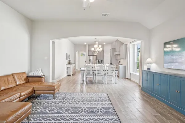 a living room with furniture and a wooden floor