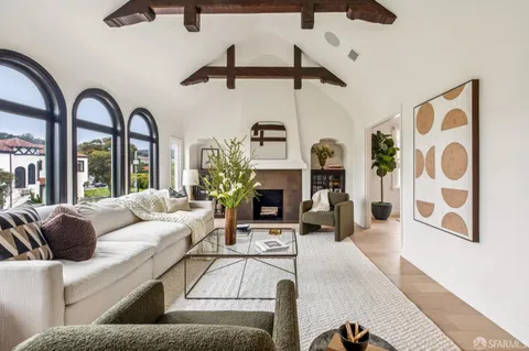 a large kitchen with stainless steel appliances granite countertop a stove and a large window
