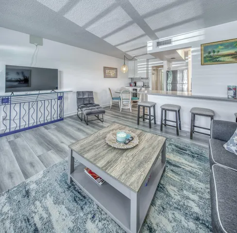 a living room with furniture and flat screen tv