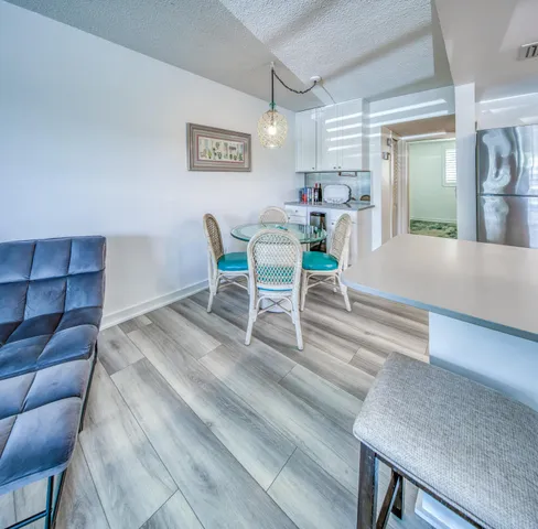 a living room with furniture and a dining table with kitchen view