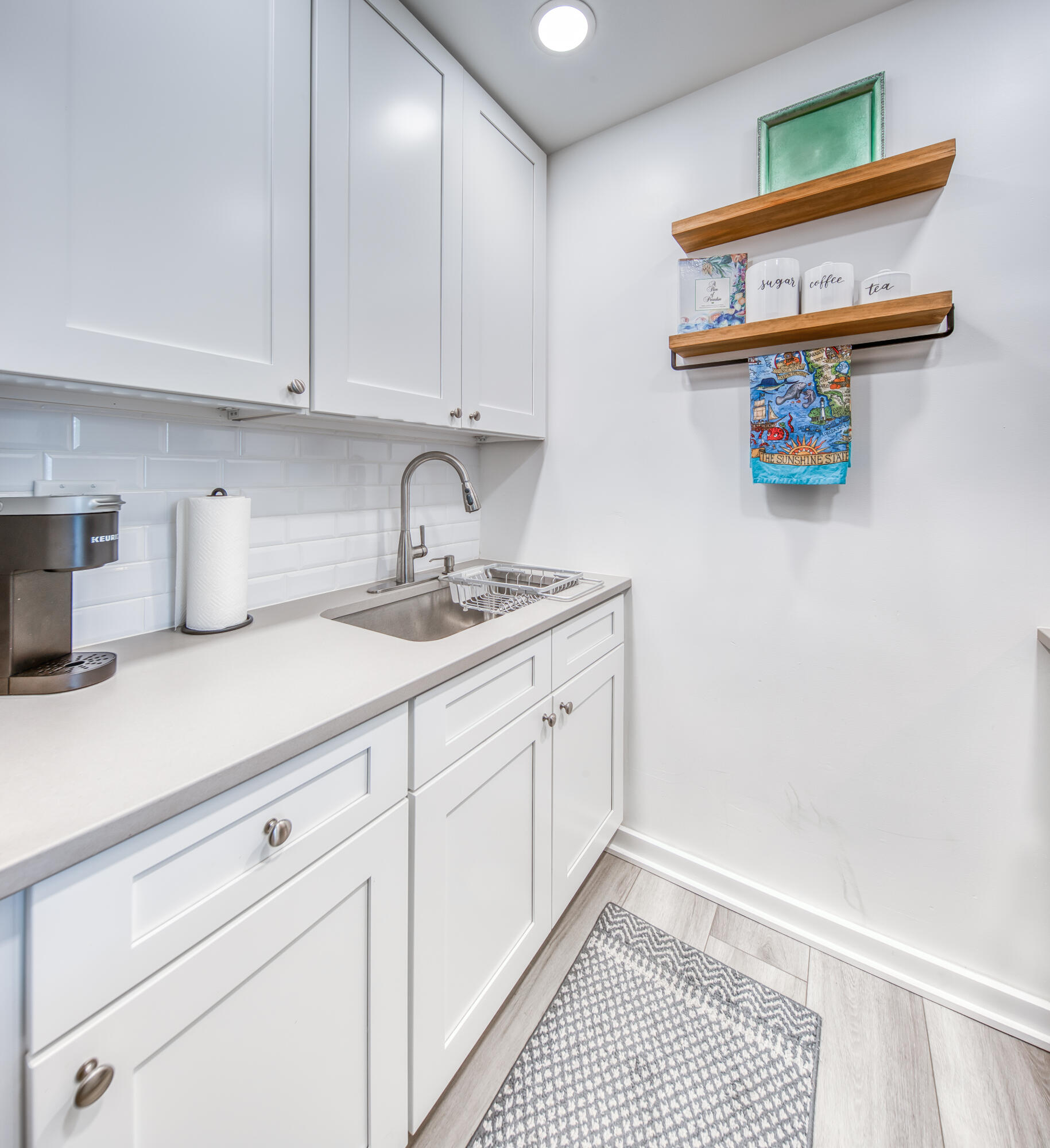 2565 South Ocean Boulevard, Unit 1040 (104) Palm Beach, FL 33480 - Photo 6 of 26 a kitchen with a sink and cabinets