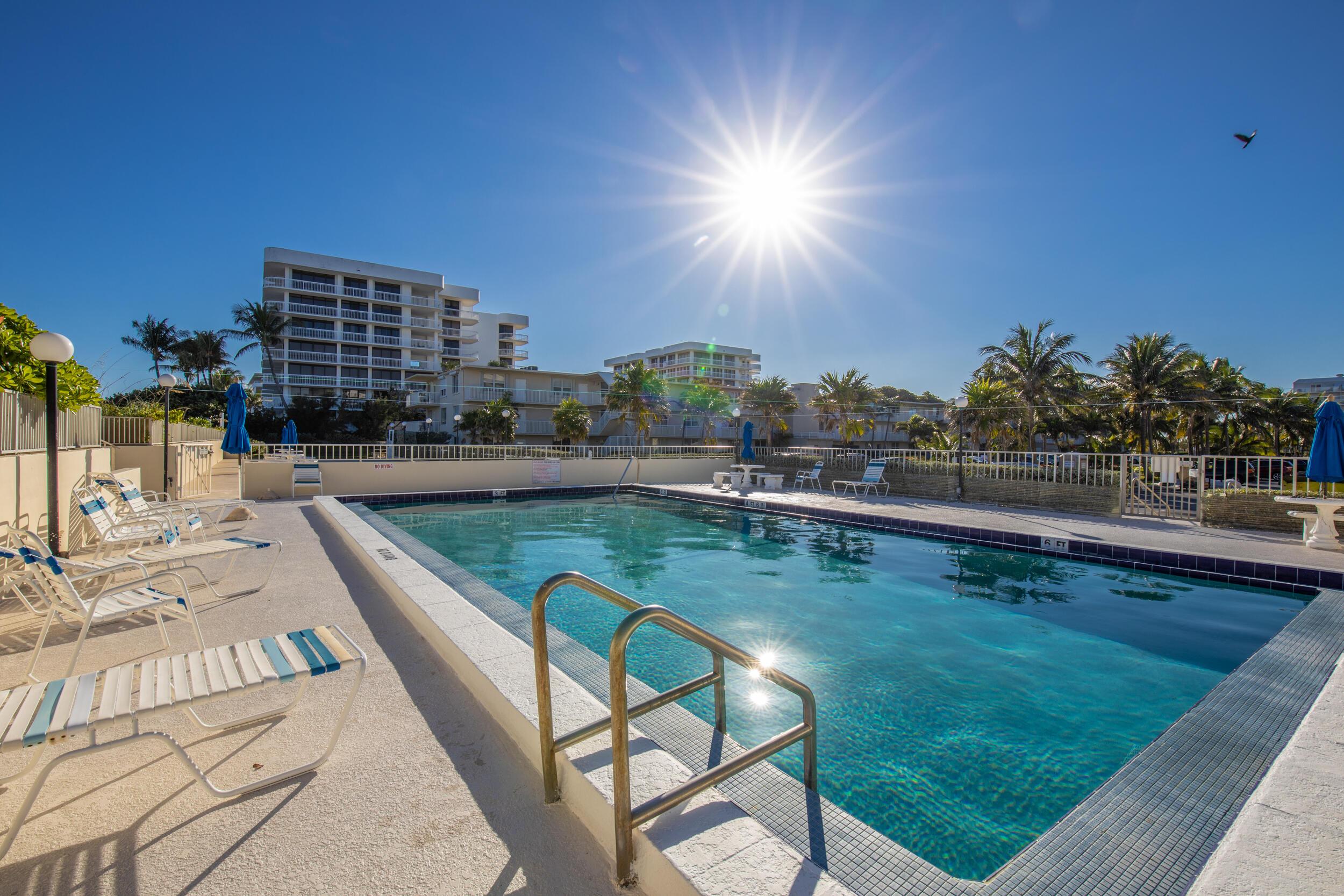 2565 South Ocean Boulevard, Unit 1040 (104) Palm Beach, FL 33480 - Photo 9 of 26 a view of a swimming pool with a lounge chairs